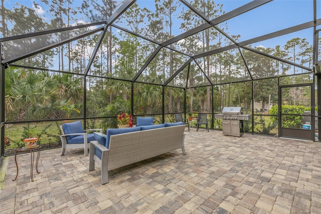 view of patio / terrace with a lanai, an outdoor hangout area, and area for grilling