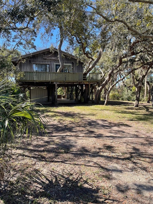 back of house with a deck