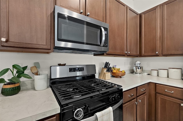 kitchen with appliances with stainless steel finishes and light countertops