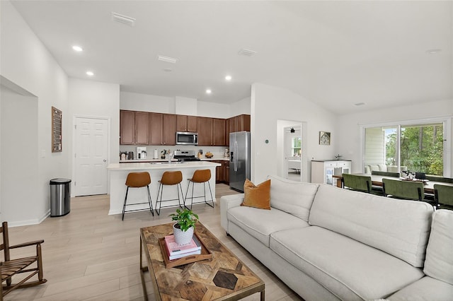 living area with light wood-type flooring, visible vents, and recessed lighting