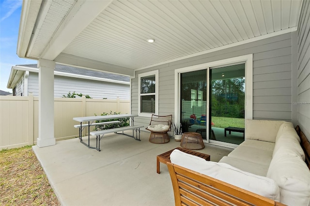 view of patio featuring outdoor lounge area and fence