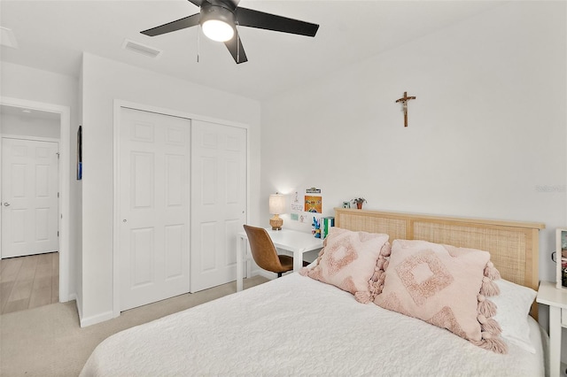 bedroom with baseboards, visible vents, a ceiling fan, carpet flooring, and a closet