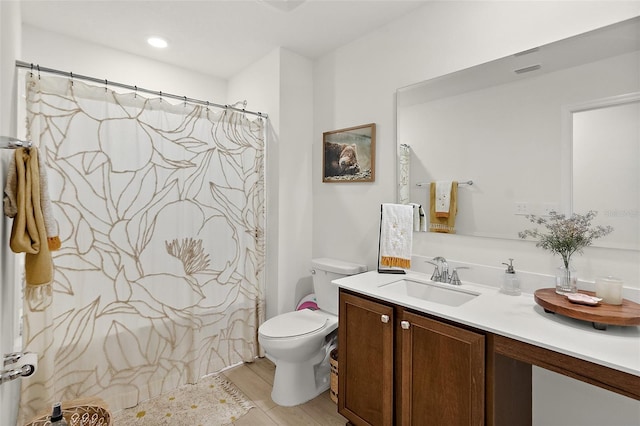 bathroom with toilet, a shower with curtain, visible vents, and vanity