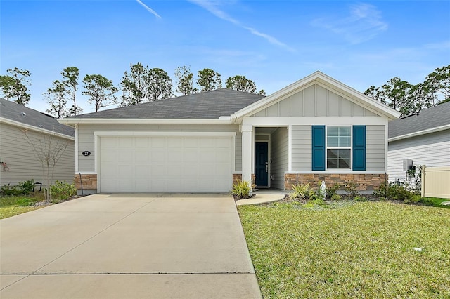 view of front of home featuring driveway, stone siding, an attached garage, board and batten siding, and a front yard