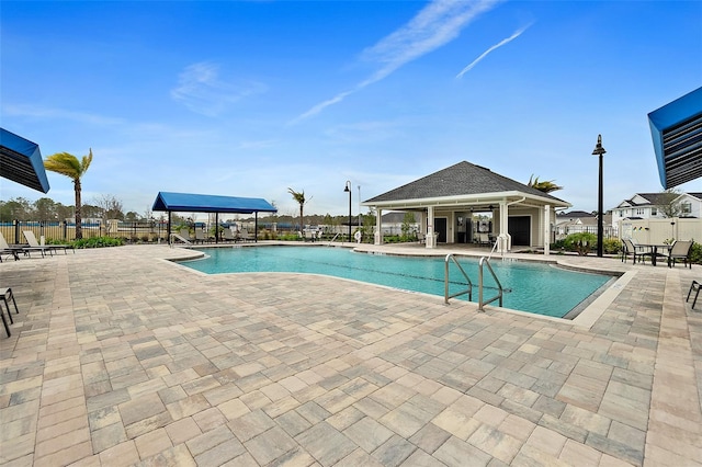 pool featuring fence and a patio