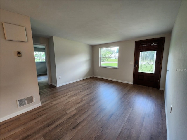 entryway featuring a wealth of natural light, dark wood-type flooring, visible vents, and baseboards