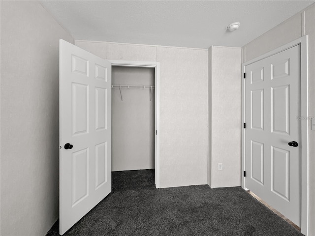 unfurnished bedroom with carpet floors and a closet