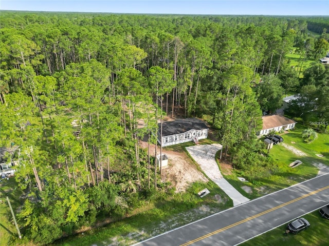 aerial view featuring a wooded view