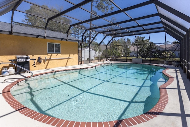 pool with a lanai and a patio area