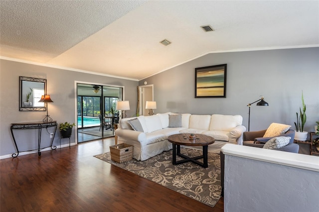 living room featuring visible vents, lofted ceiling, wood finished floors, and ornamental molding