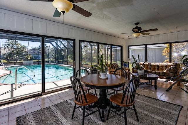 sunroom / solarium with a swimming pool and ceiling fan