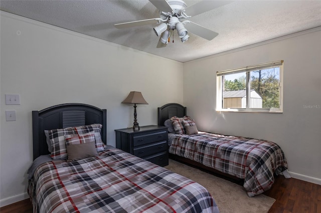 bedroom with ceiling fan, baseboards, a textured ceiling, and wood finished floors