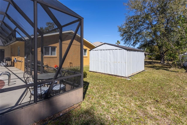 view of yard with a lanai, a storage unit, an outbuilding, and a patio