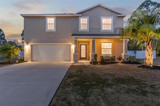 traditional-style home featuring stucco siding, fence, covered porch, concrete driveway, and a garage