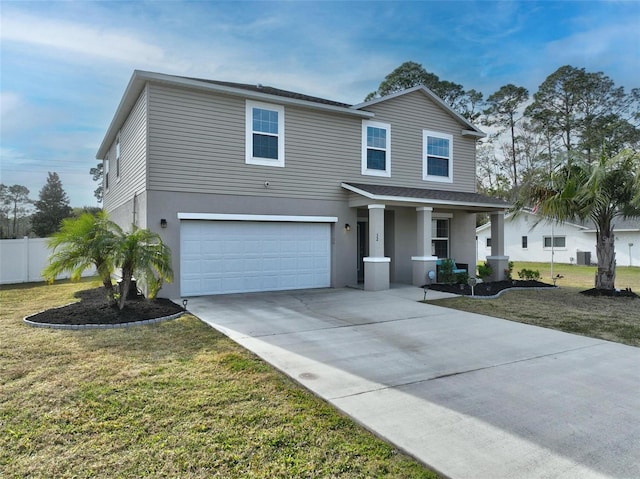 traditional home with fence, concrete driveway, a front yard, stucco siding, and a garage