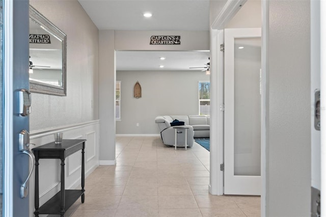 hall with light tile patterned floors, baseboards, and recessed lighting