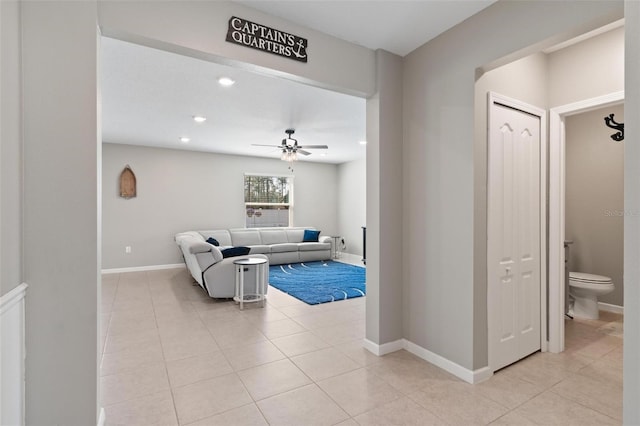 living room with light tile patterned floors, baseboards, ceiling fan, and recessed lighting