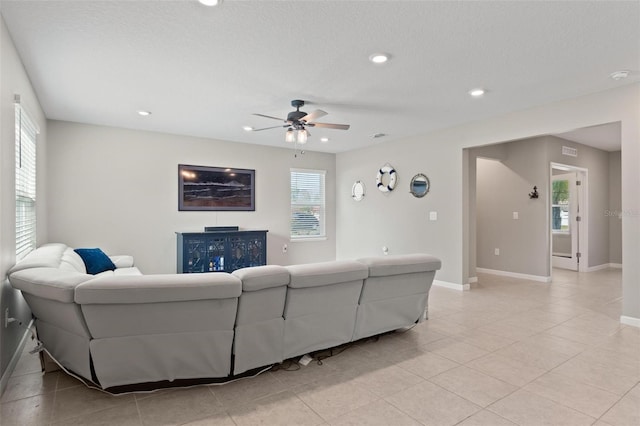 living room with light tile patterned floors, recessed lighting, baseboards, and ceiling fan