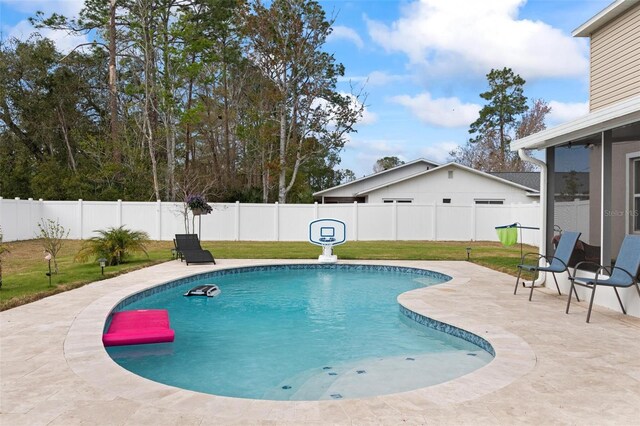 view of pool with a patio area, a fenced backyard, and a yard