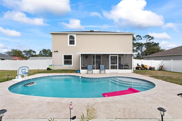 view of pool with a patio area, a yard, a fenced backyard, and a sunroom