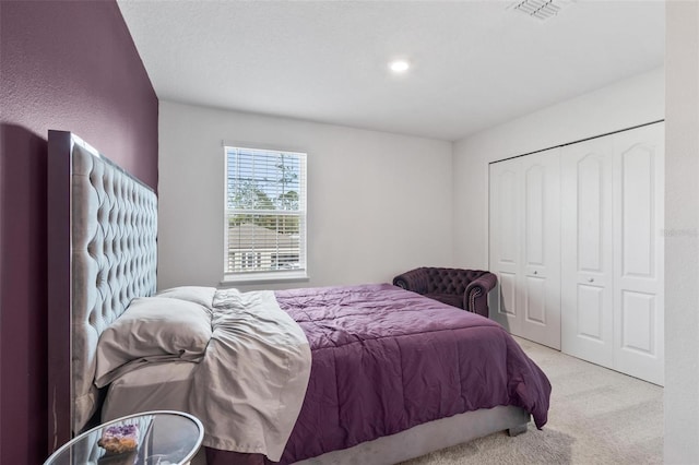 bedroom featuring a closet, visible vents, and carpet