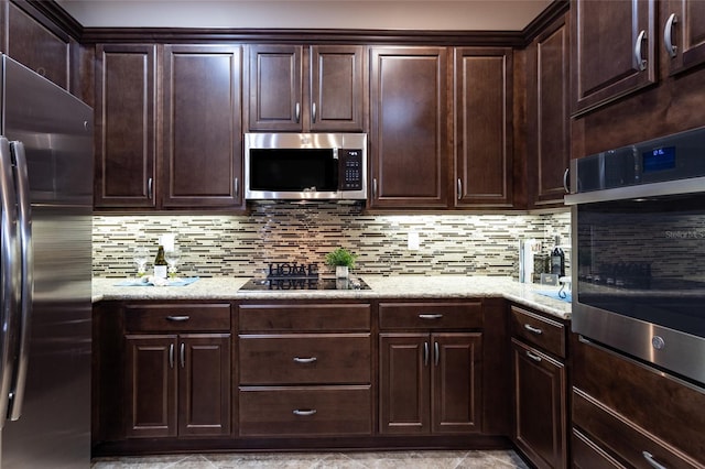 kitchen with dark brown cabinetry, stainless steel appliances, and backsplash