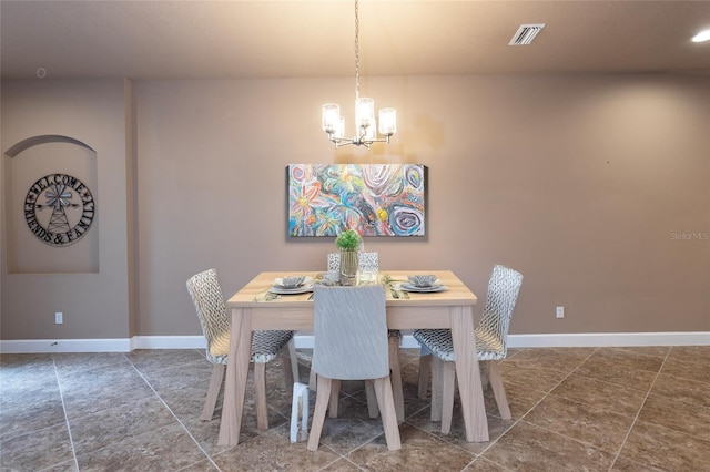 dining area with an inviting chandelier, baseboards, and visible vents