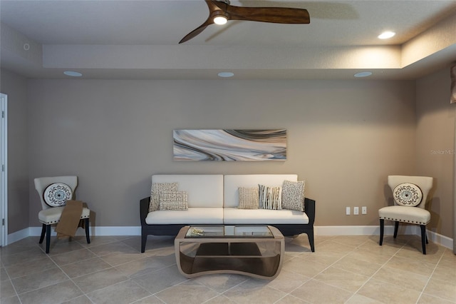 sitting room featuring baseboards, a ceiling fan, and light tile patterned flooring