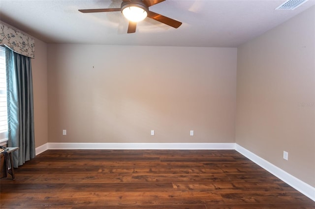 unfurnished room with visible vents, dark wood finished floors, baseboards, and ceiling fan