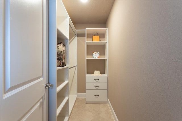 spacious closet with light tile patterned floors