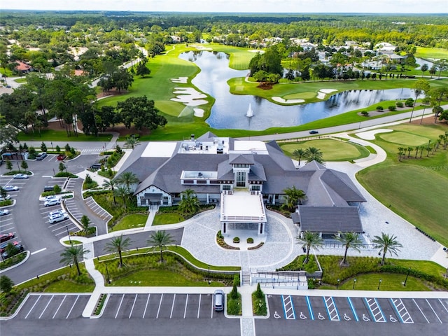 drone / aerial view featuring view of golf course and a water view