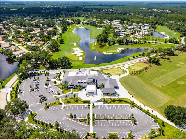 drone / aerial view with a water view, a residential view, and golf course view