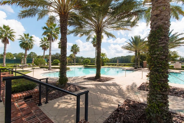 community pool with a patio area