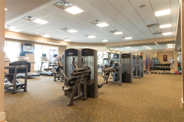 gym featuring carpet floors, visible vents, and a paneled ceiling