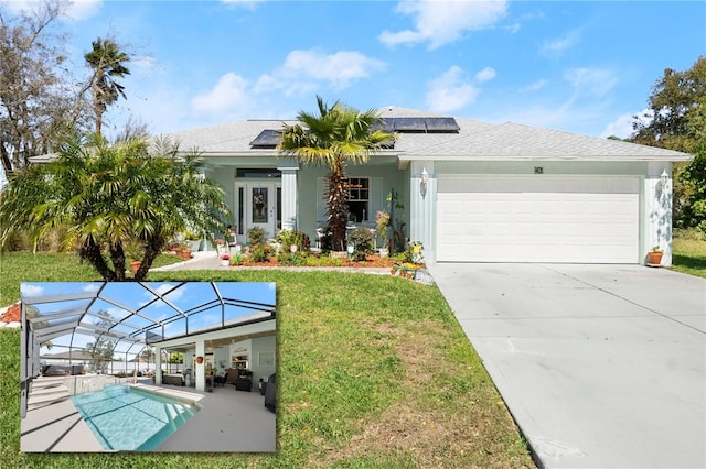 view of front of house with glass enclosure, a front yard, an outdoor pool, a garage, and roof mounted solar panels