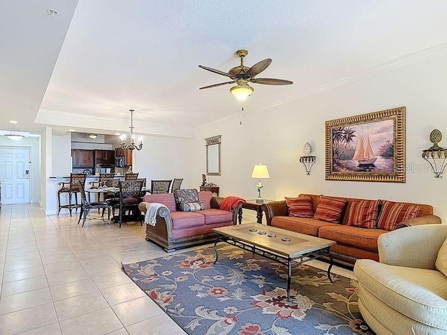 living room with light tile patterned flooring, crown molding, and ceiling fan with notable chandelier