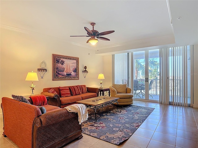 tiled living room with a wall of windows, ornamental molding, french doors, and ceiling fan