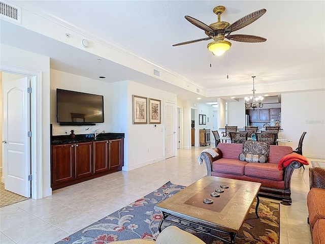 living area featuring visible vents, ornamental molding, and ceiling fan with notable chandelier