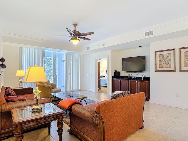 living room with visible vents, baseboards, crown molding, and ceiling fan