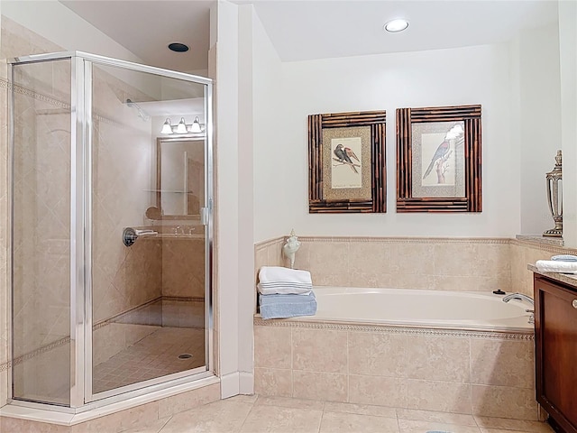 full bath featuring tile patterned floors, a garden tub, a stall shower, and vanity