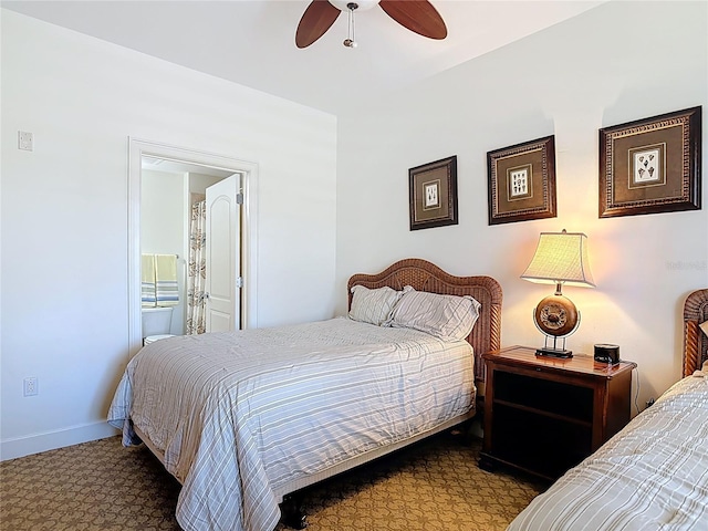 carpeted bedroom featuring baseboards and connected bathroom