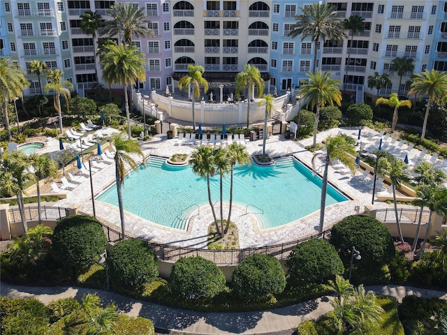 community pool featuring a patio and fence