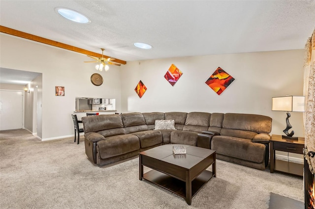 living area with a textured ceiling, light colored carpet, ceiling fan, and vaulted ceiling