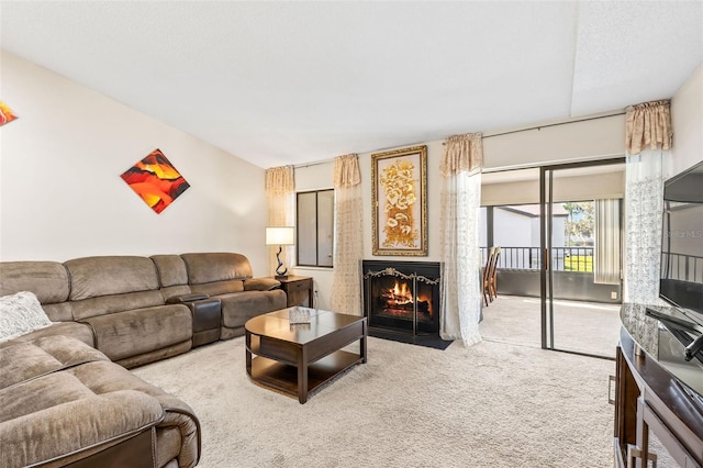 living room with a fireplace with flush hearth and light colored carpet