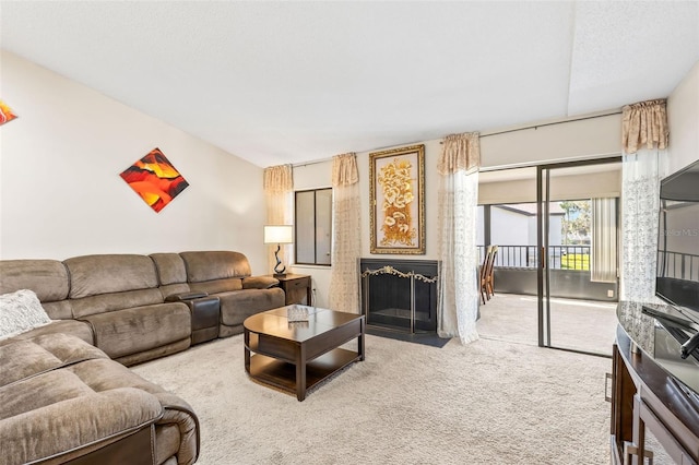 carpeted living room featuring a fireplace with flush hearth