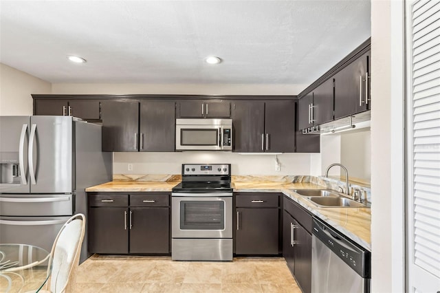 kitchen featuring dark brown cabinetry, recessed lighting, appliances with stainless steel finishes, and a sink