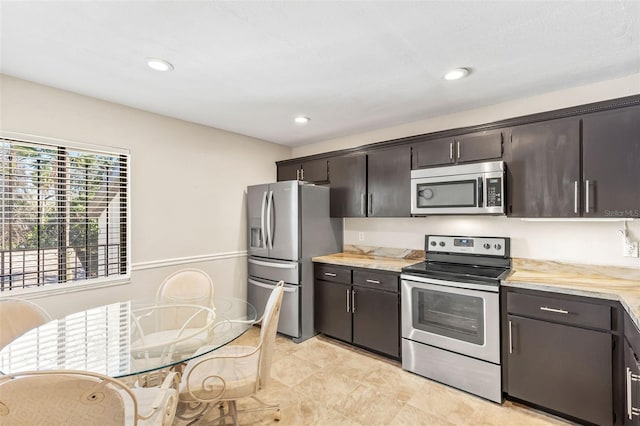 kitchen with recessed lighting, stainless steel appliances, dark brown cabinetry, and light countertops