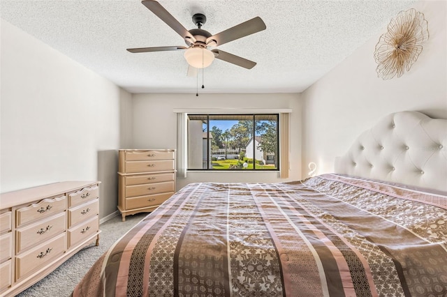 bedroom featuring light carpet, baseboards, a textured ceiling, and a ceiling fan