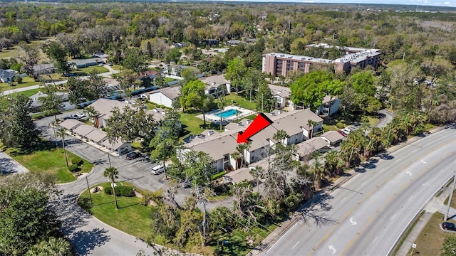 birds eye view of property featuring a forest view and a residential view