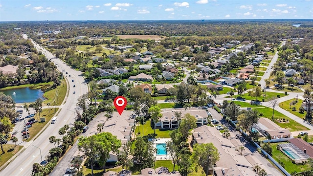 birds eye view of property with a residential view and a water view